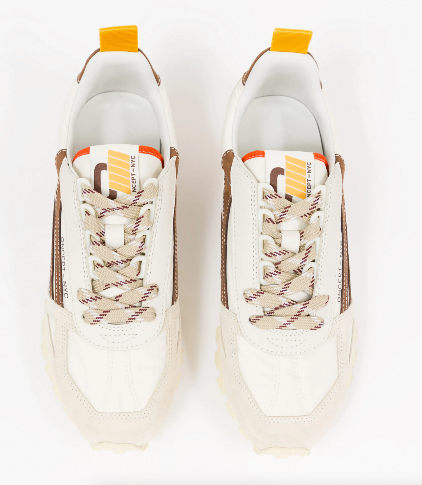 A pair of Off-White low-top Oncept sneakers shown from a top-down view on a clean white background. The sneakers feature an off-white leather upper with brown suede side panels, beige and brown striped laces, and a white tongue label with orange and yellow graphic details.