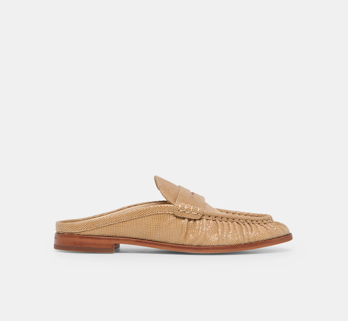A single tan textured Dolce Vita Betzy loafer with a woven strap and a low brown block heel, shown in profile against a light gray background.