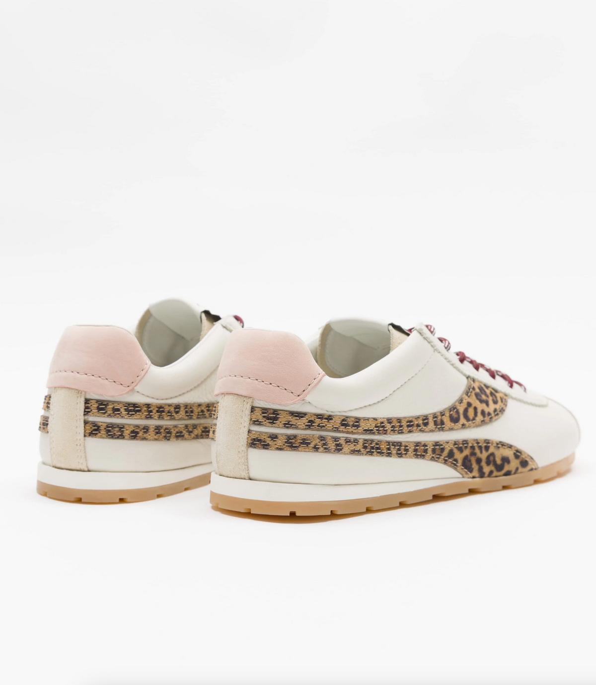 A pair of low-top Oncept sneakers shown from the side and back on a clean white background. The shoes are primarily off-white with a light pink heel tab, a leopard-print side stripe, and a gum sole.