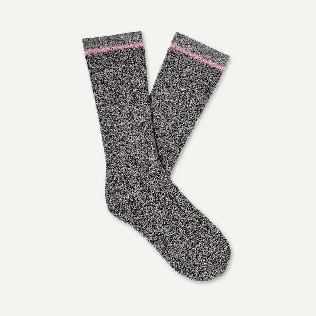 A pair of dark gray UGG Kyro Cozy crew socks with a thin pink stripe near the top cuff, displayed on a light off-white background.