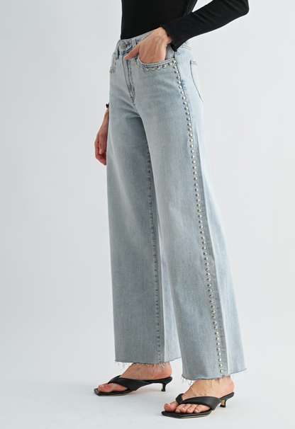 Neptune‑wash raw‑hem studded jeans with soft‑stretch denim and polished‑edgy detailing.
