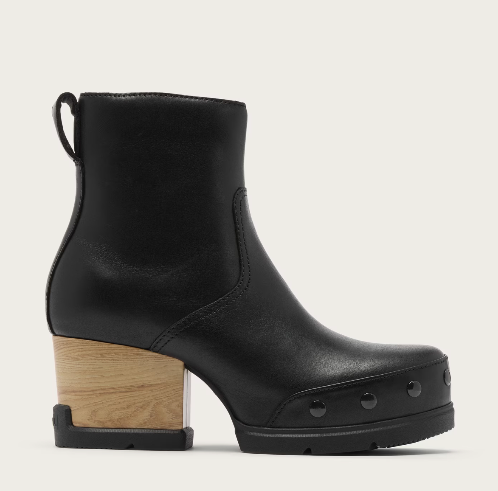 A Sorel Black Chelsea waterproof boot with front zipper and microfleece lining on a light gray background