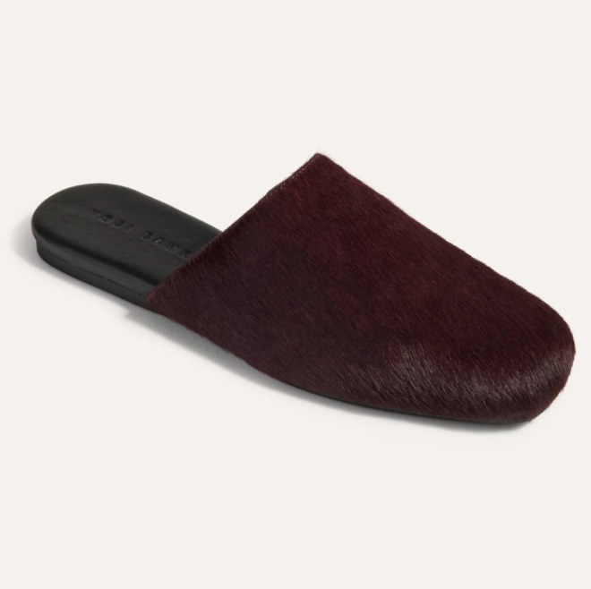 A single Yosi Samra Waverly dark burgundy hair-on-hide mule slipper with a black flat sole, photographed from a side angle on a light off-white background.