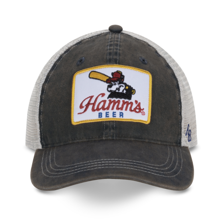 A distressed trucker-style baseball cap with a dark brown washed front panel and brim, light gray mesh back, and a large front patch reading 'Hamms BEER' with a cartoon pitcher and bat. A small blue '47' logo is visible on the side.