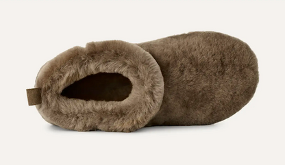 A UGG Classic Ultra Mini single plush slipper in a taupe-brown faux fur material, shown from a side profile view against a clean off-white background.