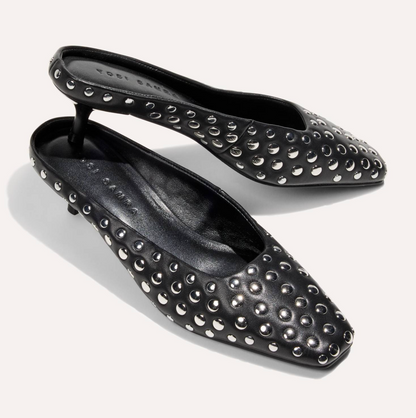 A pair of black pointed-toe flats by Yosi Samra, embellished with silver-tone metal studs, shown on a light off-white background.
