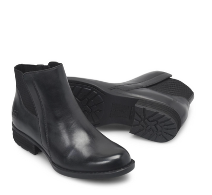 A pair of Born Kendyl black leather ankle boots, with one boot standing upright to show the side and front and the other lying down to display the sole and tread pattern, set against a plain white background.