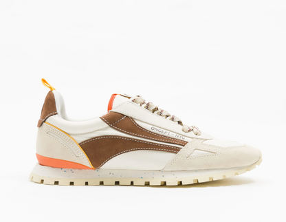 A low-top Oncept sneaker in off-white suede and brown leather with a bright orange accent midsole and heel pull tab, shown in profile against a white background.