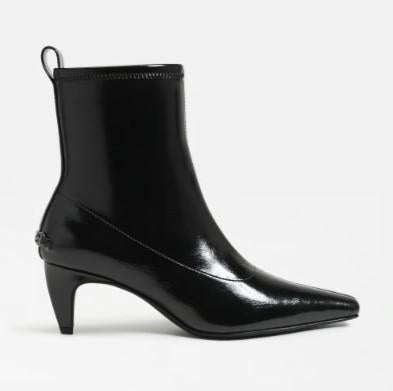 A Circus Inez black patent leather ankle boot with a pointed toe and a low kitten heel, shown from a side profile on a light gray background.