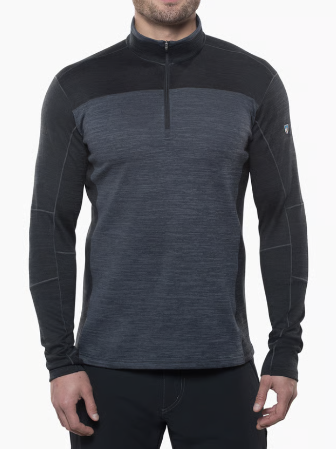 A man wearing a Kuhl Ryzer dark gray and black long-sleeve quarter-zip athletic pullover, shown from the chin down against a plain white background.