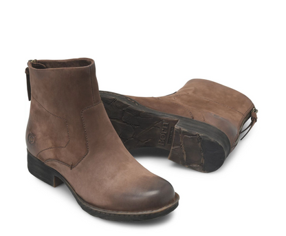 A pair of Born Mercado brown suede Chelsea-style ankle boots, with one boot standing upright to show the side profile and the other lying on its side to display the textured black sole.