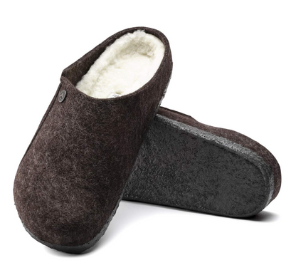 Pair of brown Birkenstock Zermatt Shearling clogs with white lining on a white background