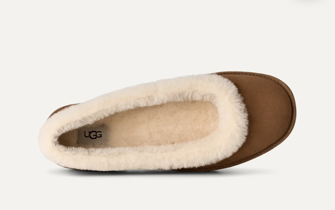 A single UGG ballet flat shown from a top-down view, featuring a smooth brown suede-like upper and a thick, fluffy cream shearling lining.