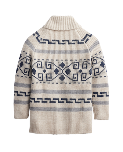 A cream-colored ribbed knit turtleneck sweater with a navy blue geometric Fair Isle pattern across the chest and shoulders, shown from the back on a white background.