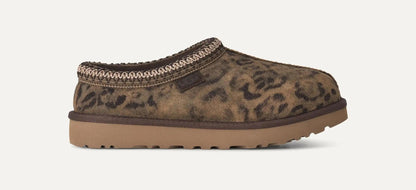 A single UGG Tasman Spotted clog-style shoe with a brown and black leopard print upper, a tan sole, and a braided trim around the opening, shown on a plain light background.