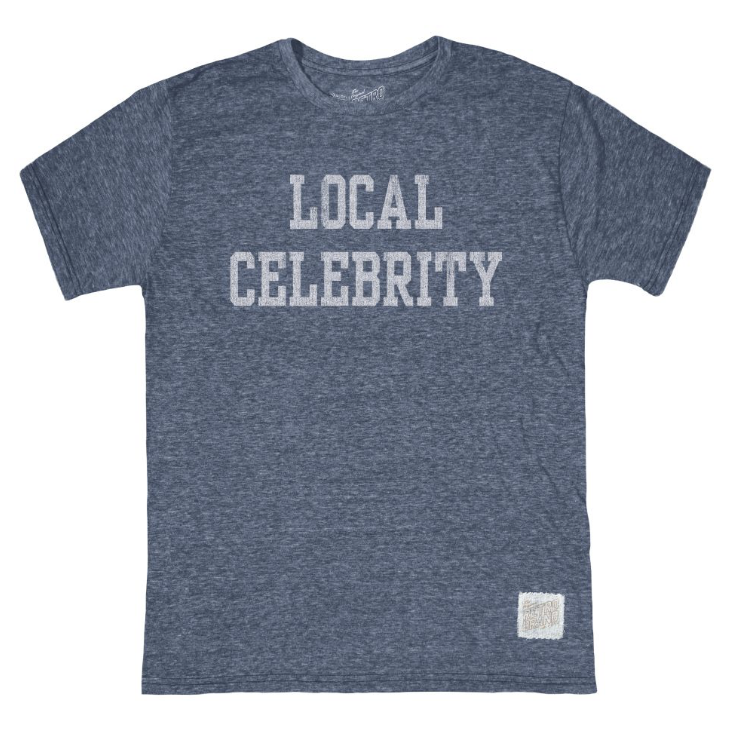 A heathered blue-gray short-sleeve t-shirt with 'LOCAL CELEBRITY' printed in distressed white block letters across the chest, shown flat on a white background.