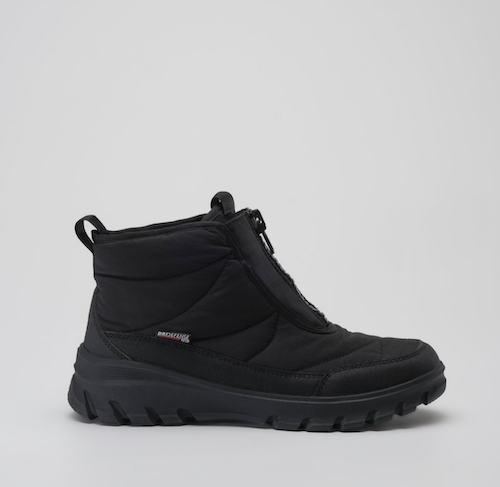A Kamik Snowdon black mid-calf winter boot with a thick lug sole, shown in profile against a light gray background. A small 'Kamik' brand tag is visible on the side.