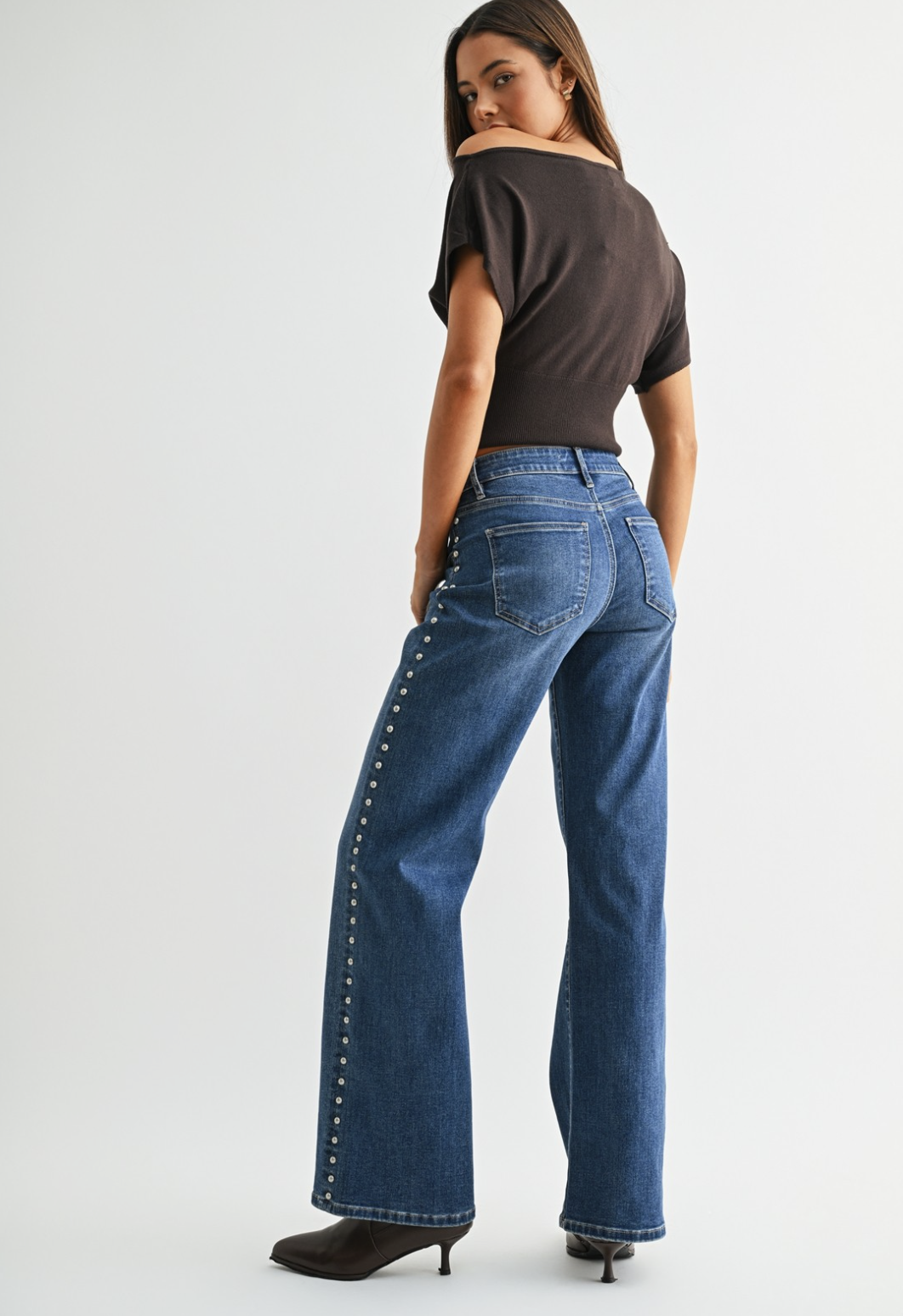 Medium blue wash wide‑leg studded jeans with soft‑stretch denim and polished‑edgy detailing.