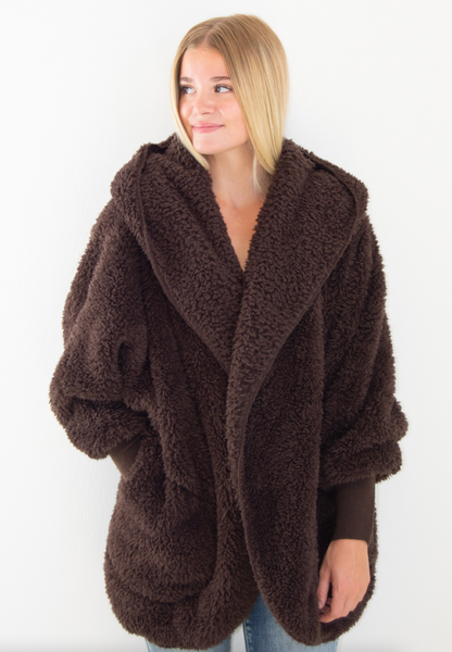 Woman wearing a Nordic Beach brown wrap against a white background