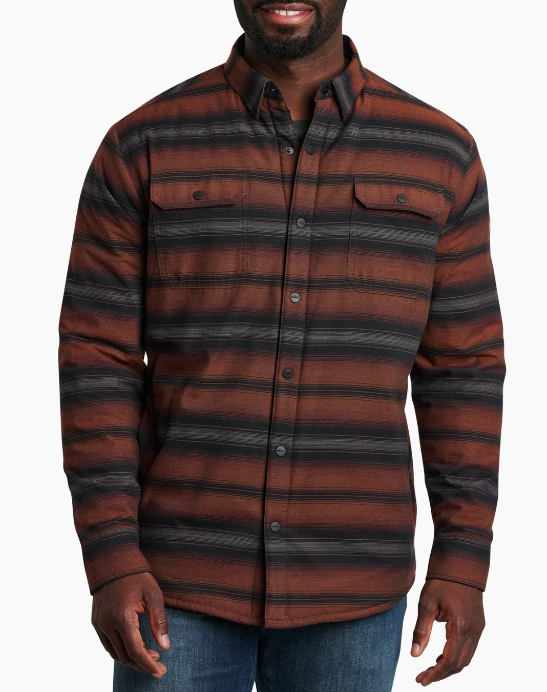 Man wearing a Kuhl Joyridr brown and black striped shirt on a white background